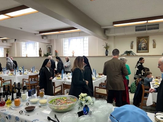 Residents and staff engaged in social dining