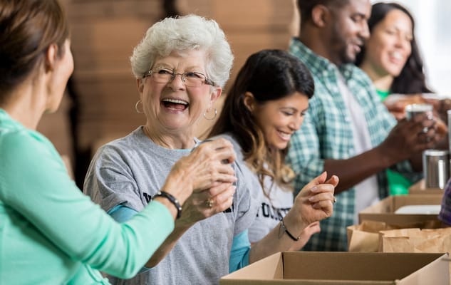 Residents and staff volunteering in an activity space
