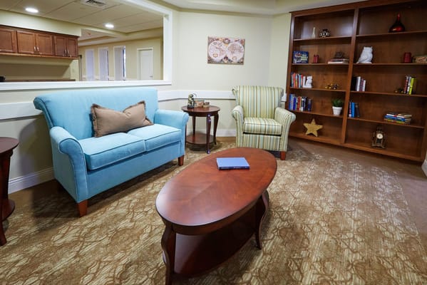 Cozy common area with comfortable seating and bookshelves