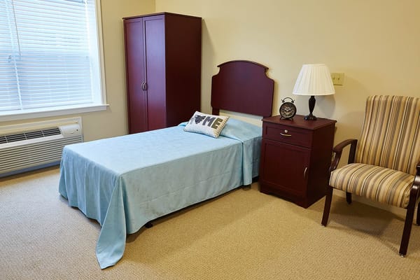 A private resident room with a bed and furniture