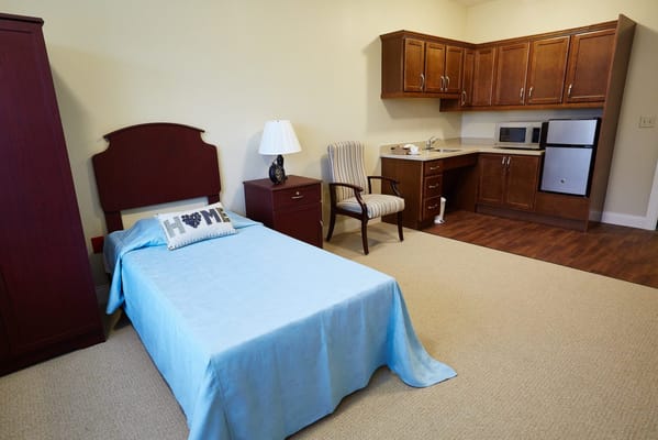 Cozy resident room with a bed and kitchenette