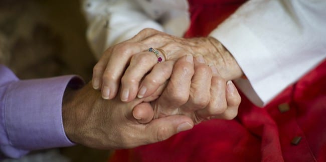 Two hands gently holding each other