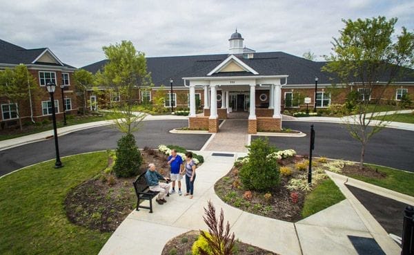 Exterior view of the Lodge at Wellmore with residents outside