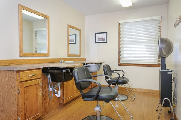 Hair salon area with styling chairs and mirrors