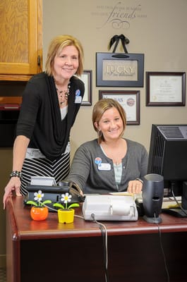Staff members at a reception desk in an office setting