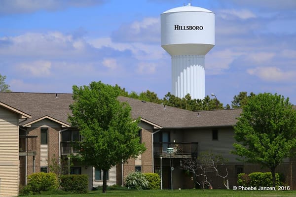 Exterior view of a senior living facility with water tower