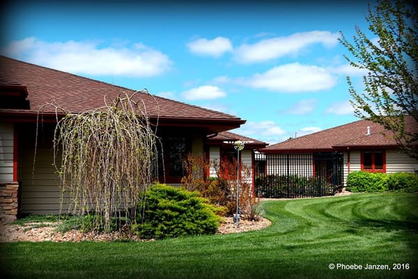 Exterior view of a senior living facility with well-maintained landscaping