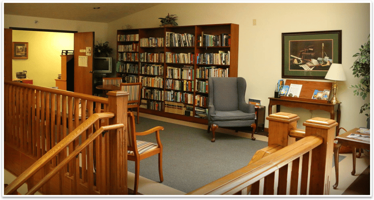 Interior view of a cozy library in a senior living facility