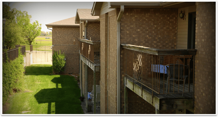 Outdoor corridor with grassy area and trees