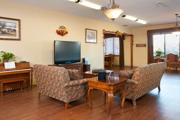 Cozy seating area in a common space with a piano