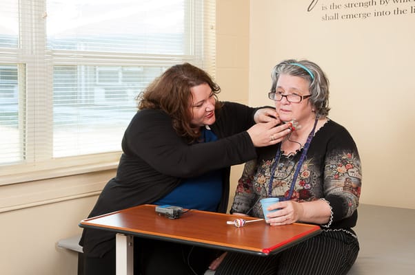A caregiver assisting a resident with a health check