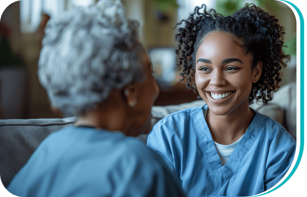 Caregiver smiling and interacting with a resident