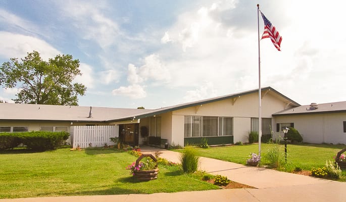 Exterior view of Life Care Center of Burlington with landscape