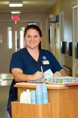 Staff member smiling at the reception desk
