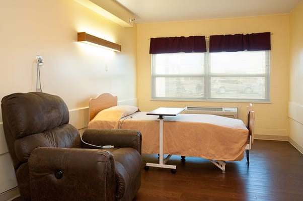 Cozy private room with a bed and recliner