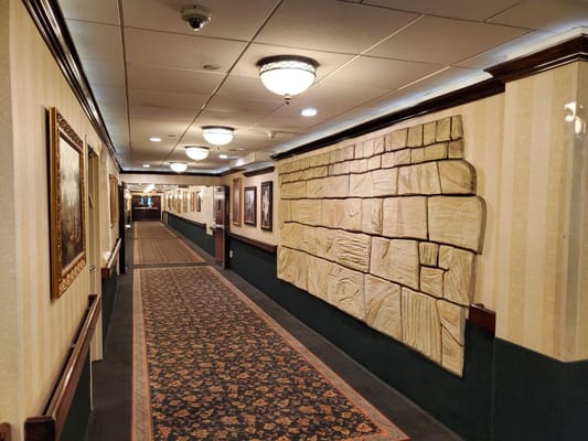 Interior hallway with decorative wall and framed pictures