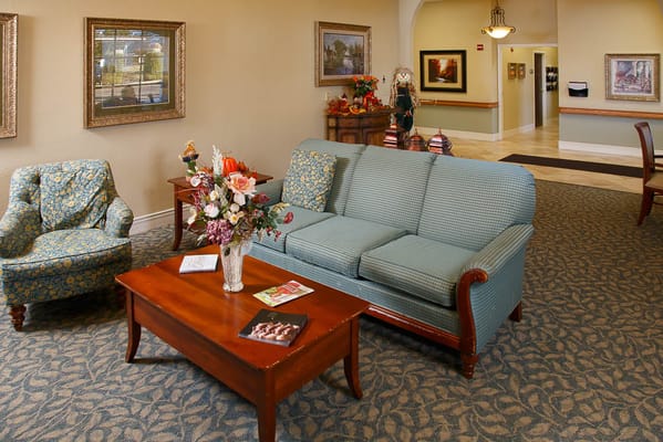 Cozy common area with seating and floral arrangement