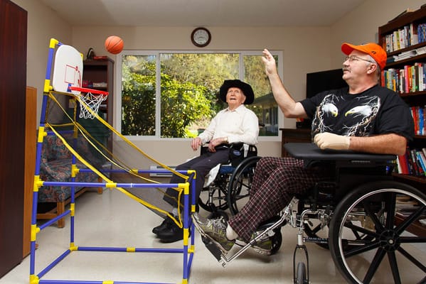 Residents playing basketball in an activity room