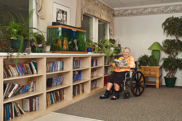 Resident reading in a cozy indoor space