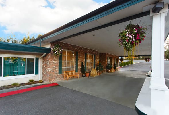 Exterior view of the facility entrance with hanging plants