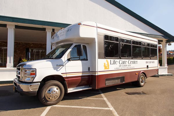 Facility shuttle bus in front of the building