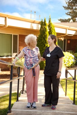 Staff member assisting a resident outside