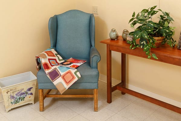 Cozy corner of a common area with a chair and plants