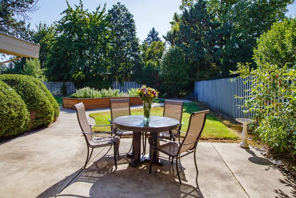 An outdoor seating area with a table and chairs