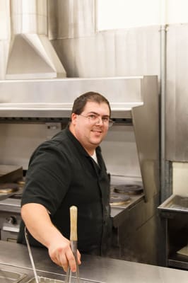 Cook preparing food in a commercial kitchen