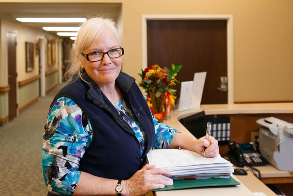 Staff member assisting at the reception desk