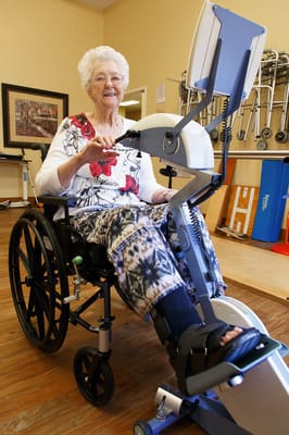 Resident using fitness equipment in a therapy room