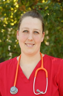 Nurse wearing scrubs with a stethoscope outdoors