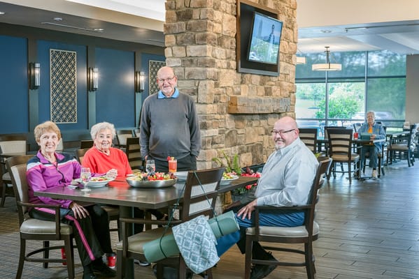 Residents enjoying a meal in the dining room area