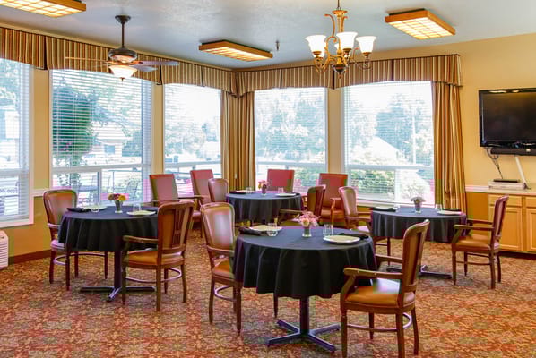 Dining area with tables and chairs set for meals