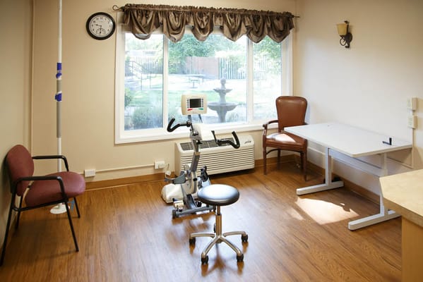 Well-equipped exercise room with a stationary bike