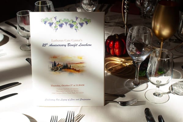 Table setting with dinner menu for anniversary event