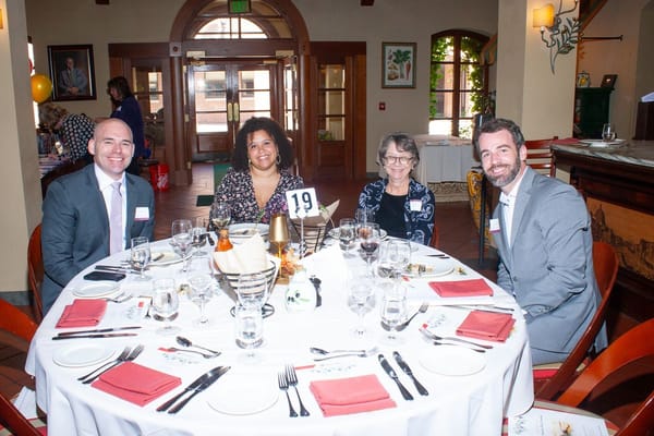 Residents and staff at a dining table during an event