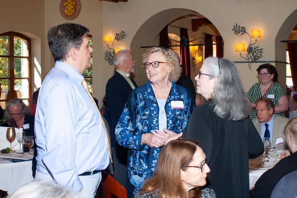 Residents and staff socializing in a dining room
