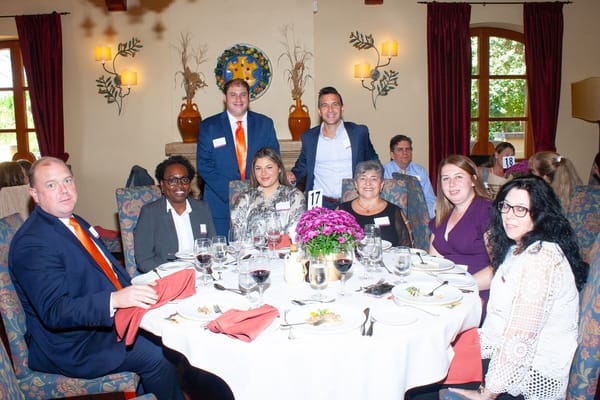 Group of people enjoying a meal at a table