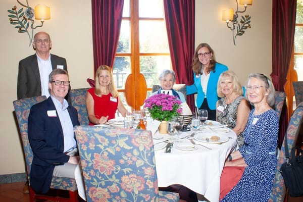 Residents and staff enjoying a meal together in a dining area