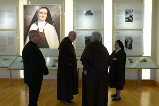 People discussing in a common area with historic displays