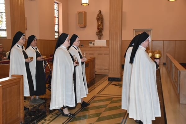 Nuns participating in a service inside a chapel