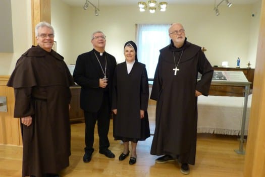 Group of four people in a facility interior