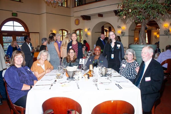 Residents and staff enjoying a meal together in the dining area