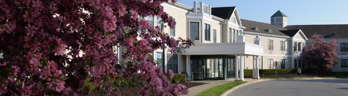 Exterior view of the facility with blooming flowers