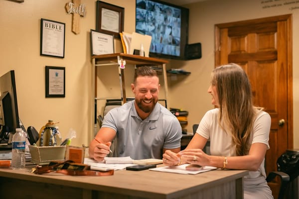 Staff members engaged in conversation at a desk