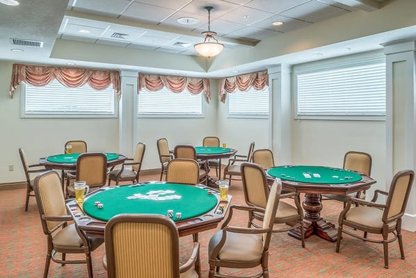 Bright common area with poker tables and chairs