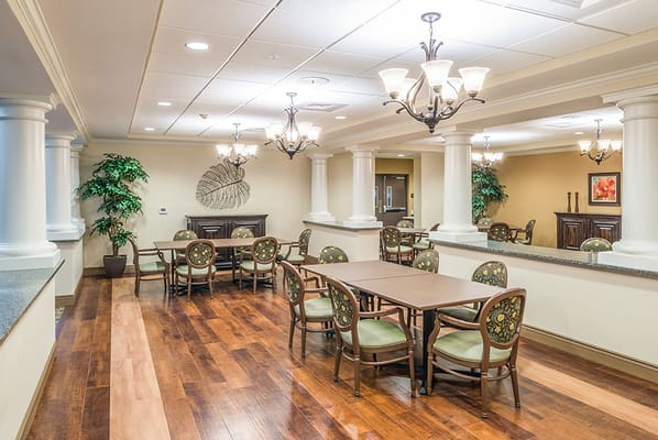Bright common area with dining tables and chairs
