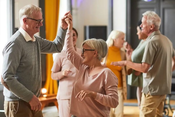 Residents dancing in a lively common area