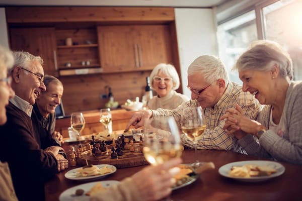 Residents enjoying a game of chess with snacks and drinks